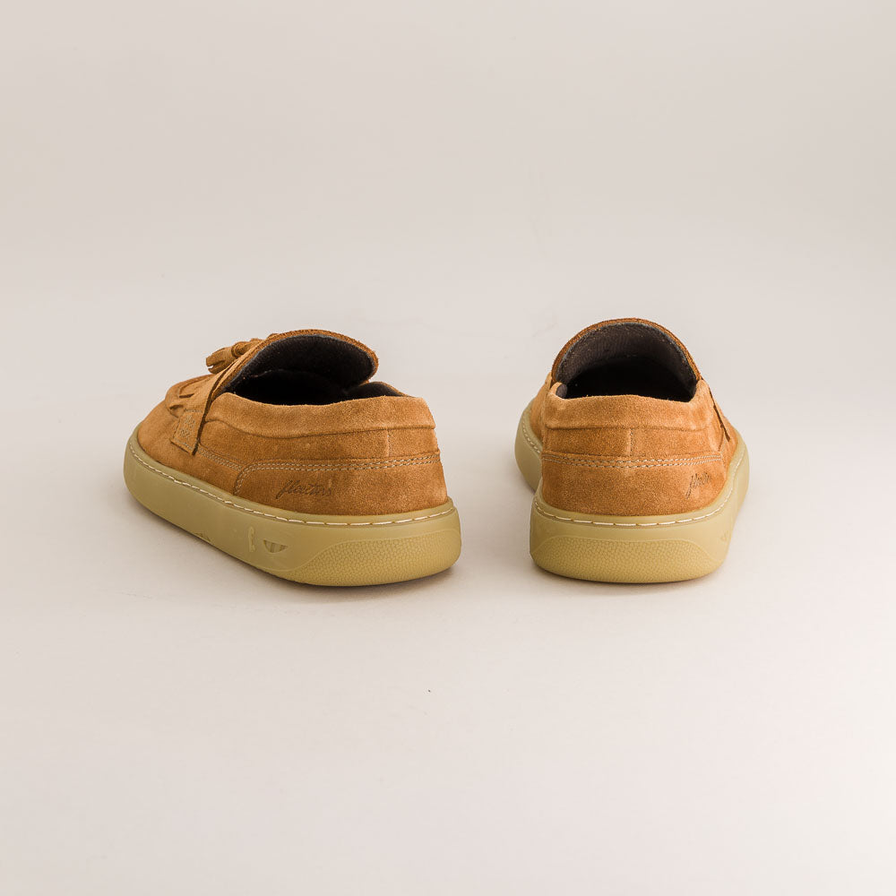 Pair of brown sneakers on a light gray background