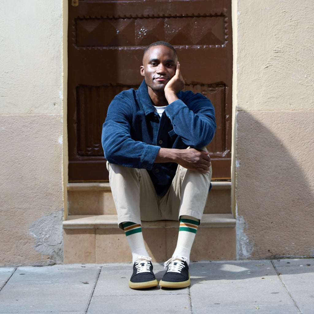 Men wearing black barefoot sneakers with white laces