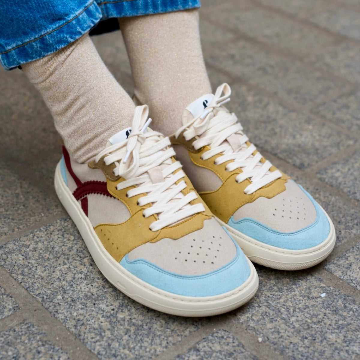 person  wearing multicolored barefoot sneakers