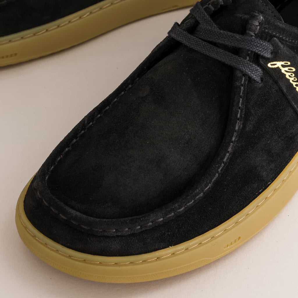 Black suede barefoot derby shoe with tan sole on a white background