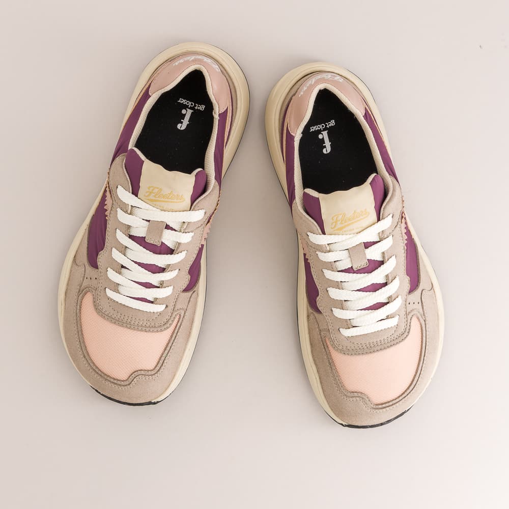 A pair of low-top barefoot sneakers shown from a top-down view on a light gray background. The shoes feature a color-blocked design with beige suede, light pink panels, purple side accents, and white laces.