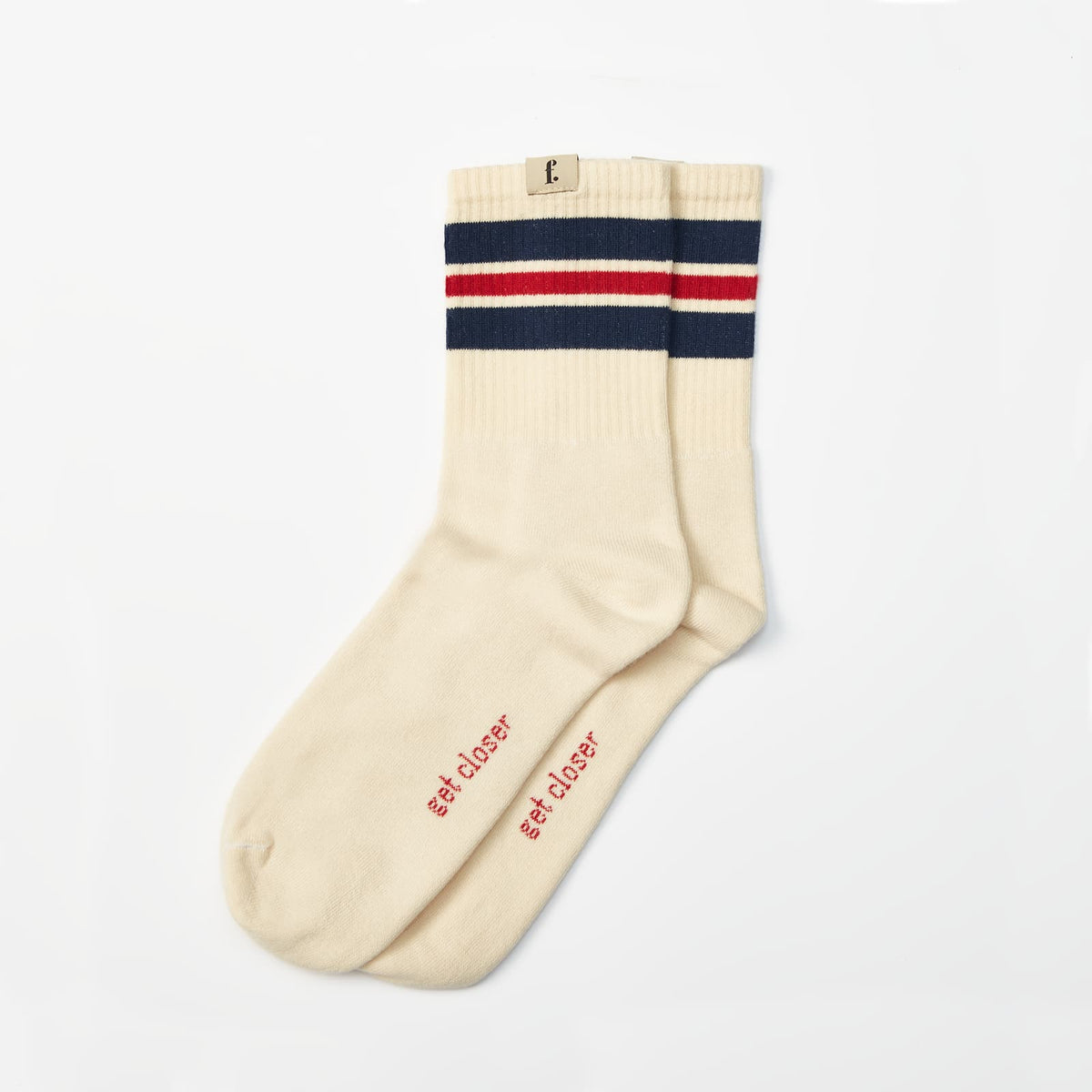 A pair of cream-colored barefoot socks with navy and red stripes at the ribbed cuff, featuring the red embroidered text 'get closer' on the sole, displayed on a clean white background.