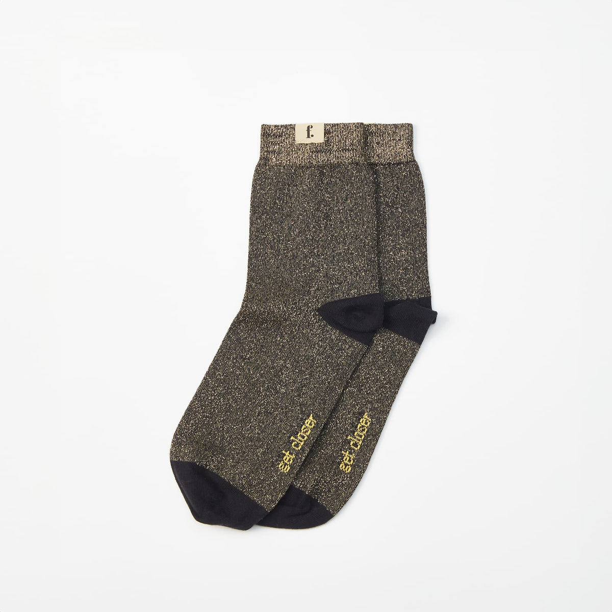 A pair of barefoot socks in a dark brown and black speckled pattern, featuring solid black heels, toes, and soles.