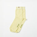A pair of pale yellow barefoot socks with olive green embroidered text reading 'get closer' on the toes, displayed on a clean white background.