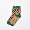A pair of barefoot socks with a tan and black leopard print pattern, featuring solid green cuffs, heels, and toes, with the brand name 'gat closer' printed on the soles.