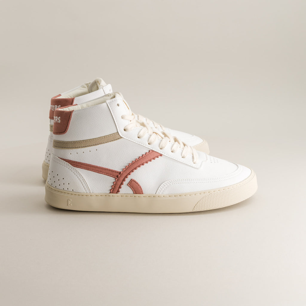 White high-top sneaker with red and brown accents on a light gray background
