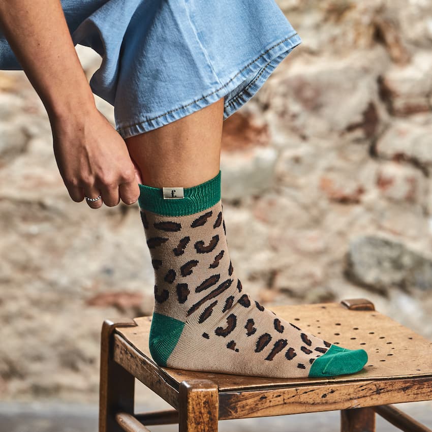 Someone wearing a leopard barefoot socks
